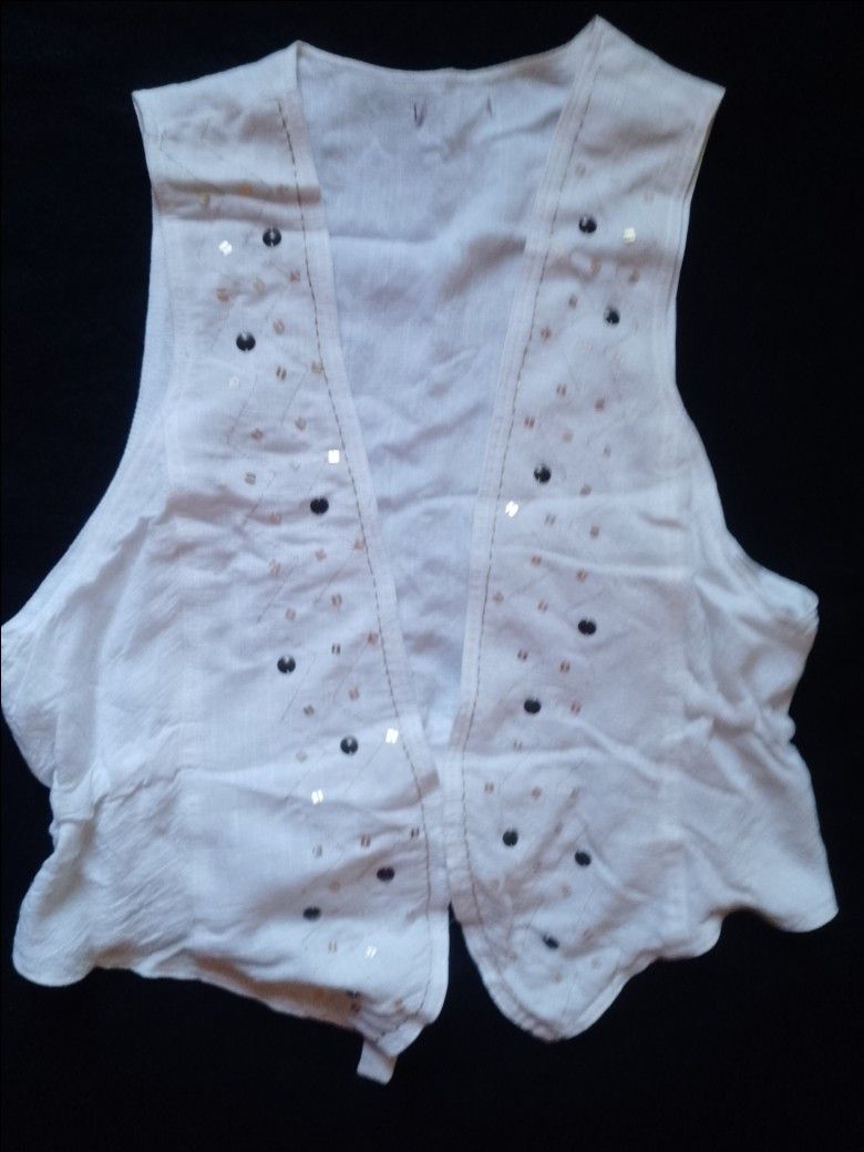 White Sleeveless Vest with Sequins and Beads (Category: Sleeveless) located in Pasig City. Submitted by marjukka (Listing ID 1455213493, Image 1). Description: Chic white sleeveless vest with bead and sequin embellishments. Features an open front, ruffled back hem with a tie, and lightweight material perfect for layering..