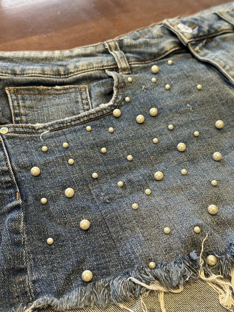 Zara Basic Denim Shorts with Pearl Embellishments (Category: Shorts) located in Makati City. Submitted by myclothesdefineme (Listing ID 1455194896, Image 2). Description: - Cute distressed denim shorts from Zara Basic - Features pearl embellishments on the front - Frayed hem detail for a trendy look - Size EUR 42 (USA 10, MEX 32) - Made in Bangladesh - Ideal for a stylish, casual vibe.
