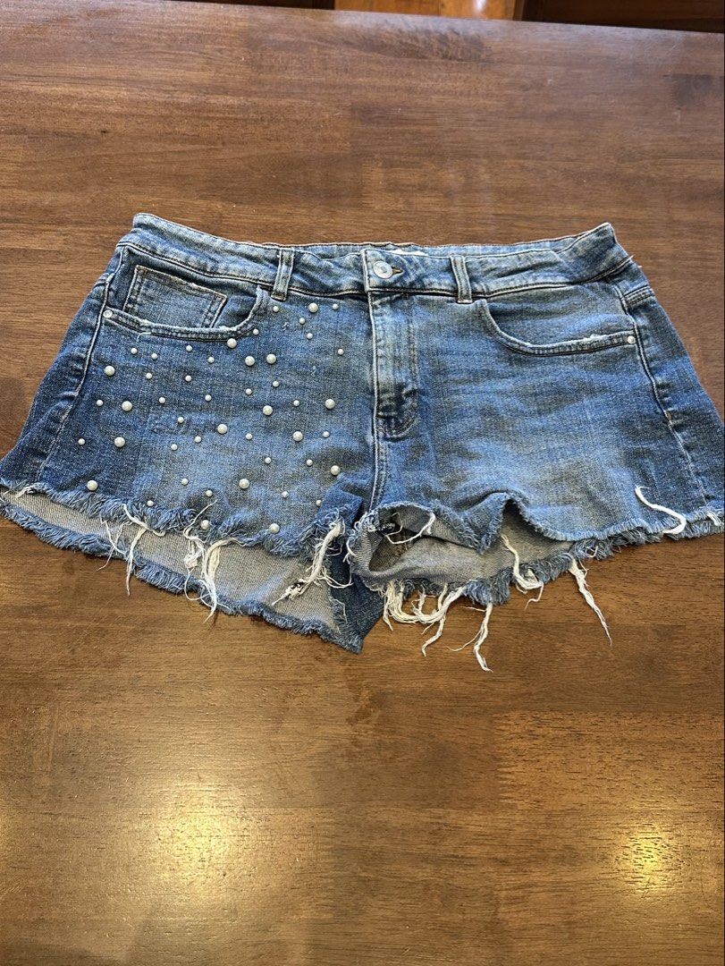 Zara Basic Denim Shorts with Pearl Embellishments (Category: Shorts) located in Makati City. Submitted by myclothesdefineme (Listing ID 1455194896, Image 1). Description: - Cute distressed denim shorts from Zara Basic - Features pearl embellishments on the front - Frayed hem detail for a trendy look - Size EUR 42 (USA 10, MEX 32) - Made in Bangladesh - Ideal for a stylish, casual vibe.