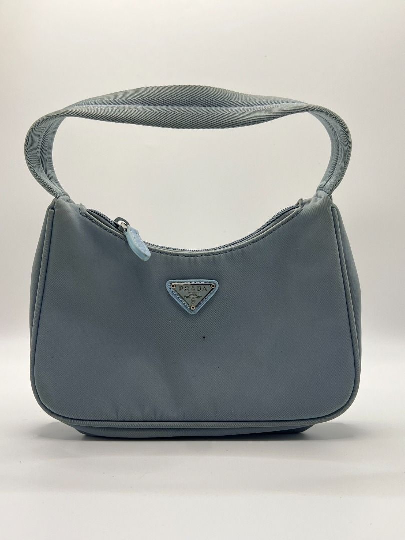 ® Prada Tessuto Nylon Mini Hobo Bag (Category: Luxury Bags & Wallets) located in San Fernando. Submitted by therarevue (Listing ID 1455401788, Image 1). Description: ═══════ ʙʀᴀɴᴅ: PRADA ɴᴏᴛᴇꜱ ᴏɴ ᴡᴇᴀʀ: ￫ no significant wear noted ￫ minimal stains *𝘞𝘦𝘢𝘳 𝘢𝘯𝘥 𝘵𝘦𝘢𝘳 𝘪𝘴 𝘦𝘹𝘱𝘦𝘤𝘵𝘦𝘥 𝘰𝘯 𝘱𝘳𝘦-𝘰𝘸𝘯𝘦𝘥 𝘱𝘪𝘦𝘤𝘦𝘴 — 𝘮𝘰𝘴𝘵 𝘤𝘰𝘮𝘮𝘰𝘯𝘭𝘺 𝘰𝘯 𝘩𝘢𝘯𝘥𝘭𝘦𝘴, 𝘤𝘰𝘳𝘯𝘦𝘳𝘴, 𝘭𝘪𝘯𝘪𝘯𝘨, 𝘢𝘯𝘥 𝘩𝘢𝘳𝘥𝘸𝘢𝘳𝘦. 𝘗𝘭𝘦𝘢𝘴𝘦 𝘢