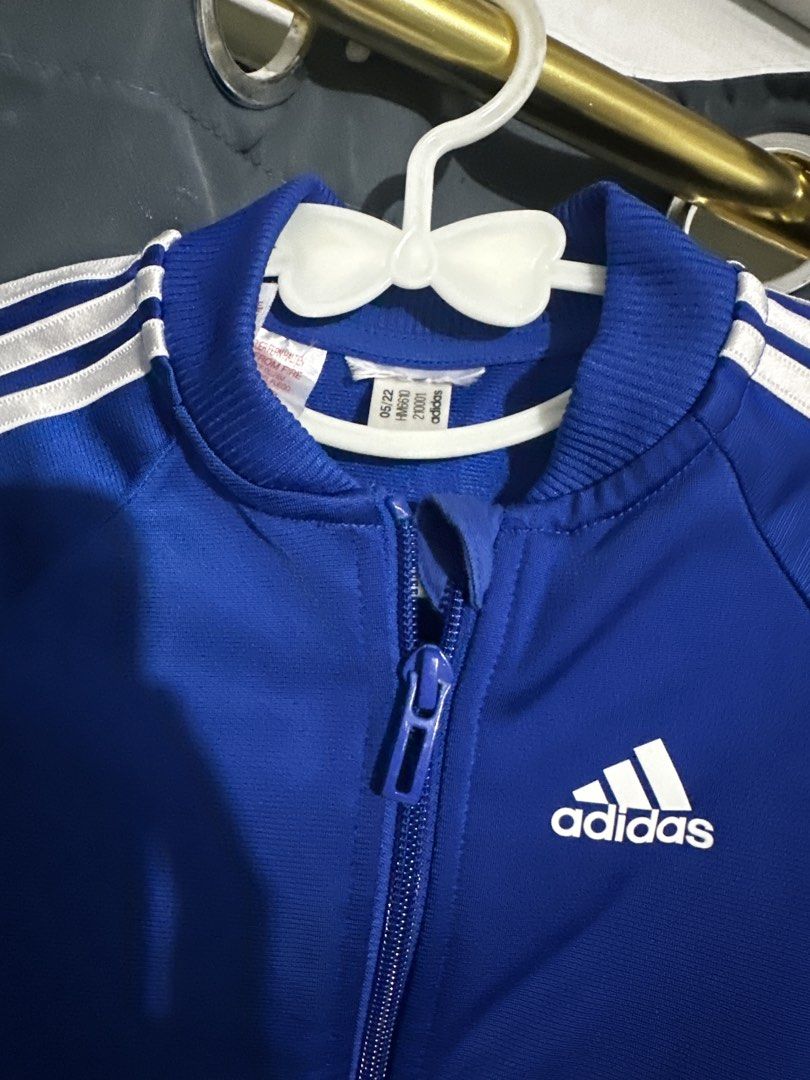Adidas Blue Tracksuit Set (Category: Babies & Kids Fashion) located in Muntinlupa City. Submitted by abnar (Listing ID 1455497317, Image 2). Description: - Blue Adidas tracksuit set - Includes jacket and pants - Classic three stripes on sleeves and legs - Zipper closure on jacket - Comfortable material - Ideal for sports or casual wear.