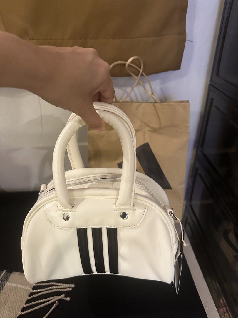 Adidas Mini Boston Bag White Black Stripes (Category: Purses & Pouches) located in Mariveles. Submitted by uno_gal_alpha (Listing ID 1455335491, Image 3). Description: - White mini Boston bag - Iconic black Adidas stripes - Secure zip closure - Two comfortable top handles - Brand new with original tags attached - Compact size, ideal for essentials - Versatile for sporty or casual outfits Bought in Korea 🇰🇷.