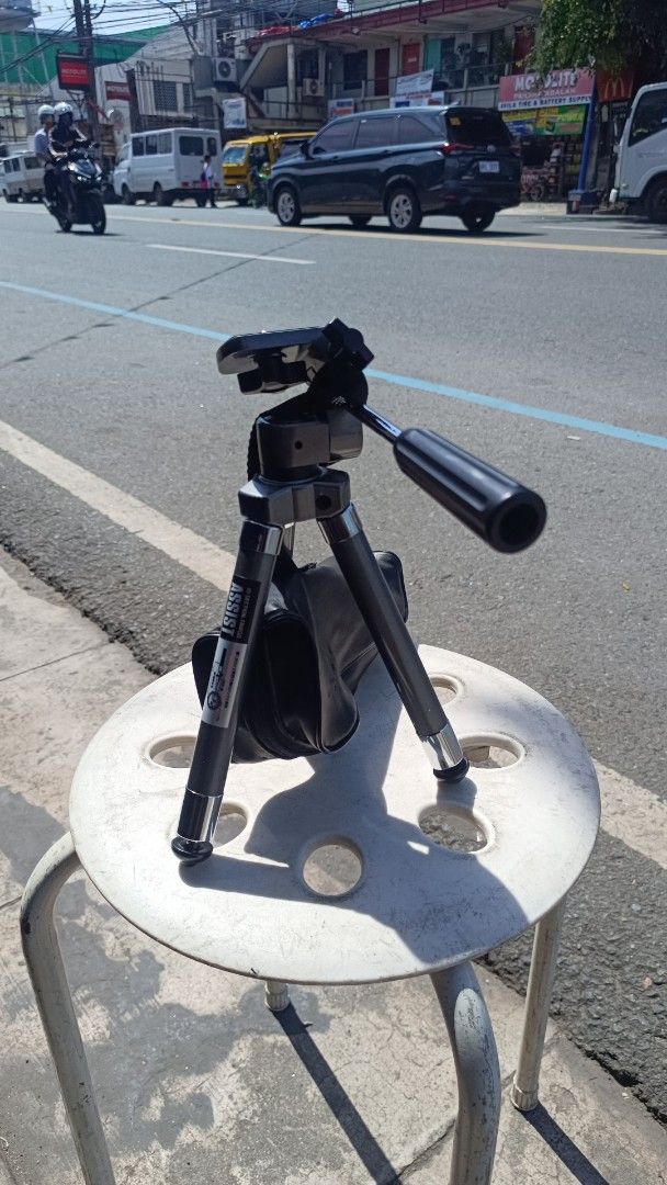 ASSIST Mini Tripod with Bag (Category: Tripods & Monopods) located in Manila. Submitted by rocksolid227 (Listing ID 1455344334, Image 1). Description: - Compact mini tripod, perfect for travel or small spaces. - Adjustable legs for versatile positioning. - Head tilts and pans for flexible framing. - Comes with a black carrying bag for easy transport. - Suitable for phones and small cameras..