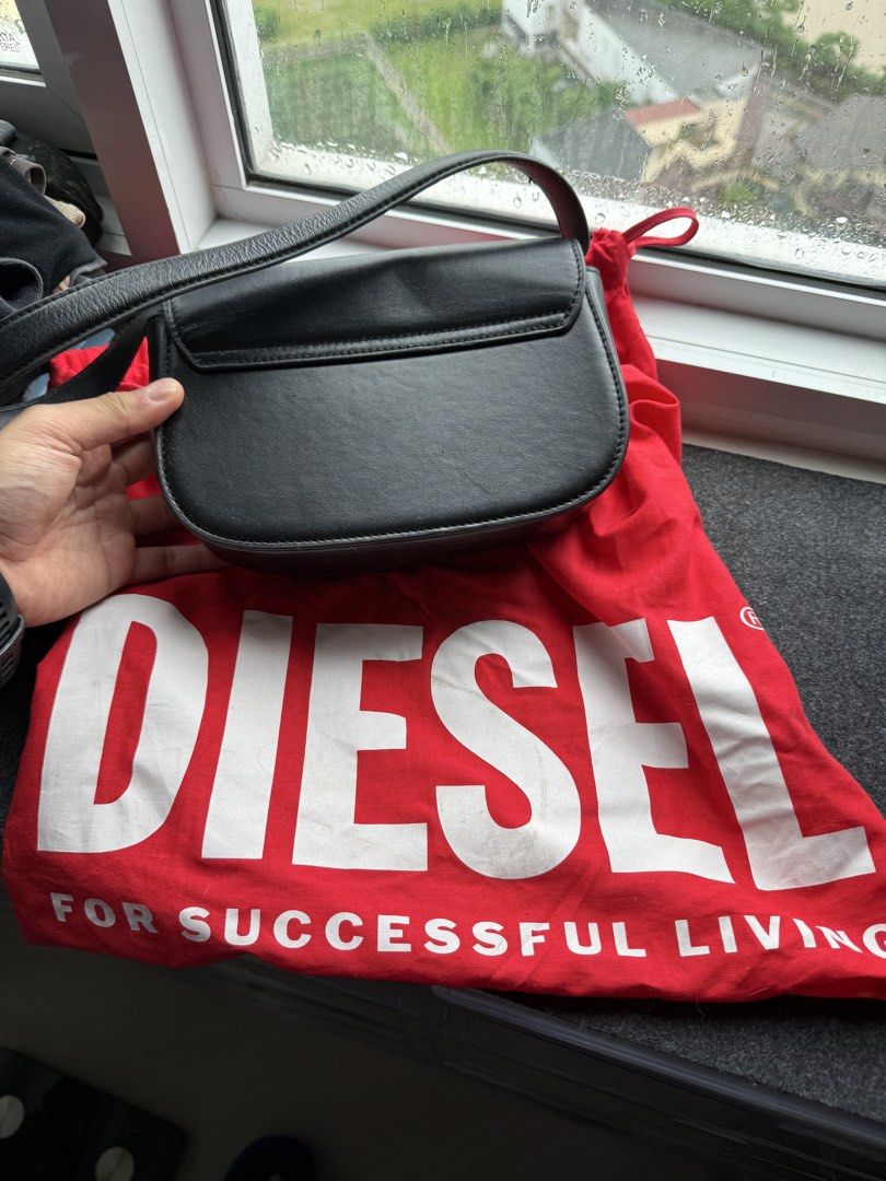 AUTHENTIC Diesel 1DR Black Leather Bag (Category: Shoulder Bags) located in Pasig City. Submitted by kfreed (Listing ID 1455350365, Image 2). Description: Authentic Diesel 1DR Black Leather Bag | With Original Dust Bag | Excellent Condition Authentic Diesel 1DR Black Leather Shoulder Bag Purchased in Hong Kong. Condition: • Excellent condition • Well maintained • Clean interior • Minimal signs of use Includes: Original Diesel dust bag .