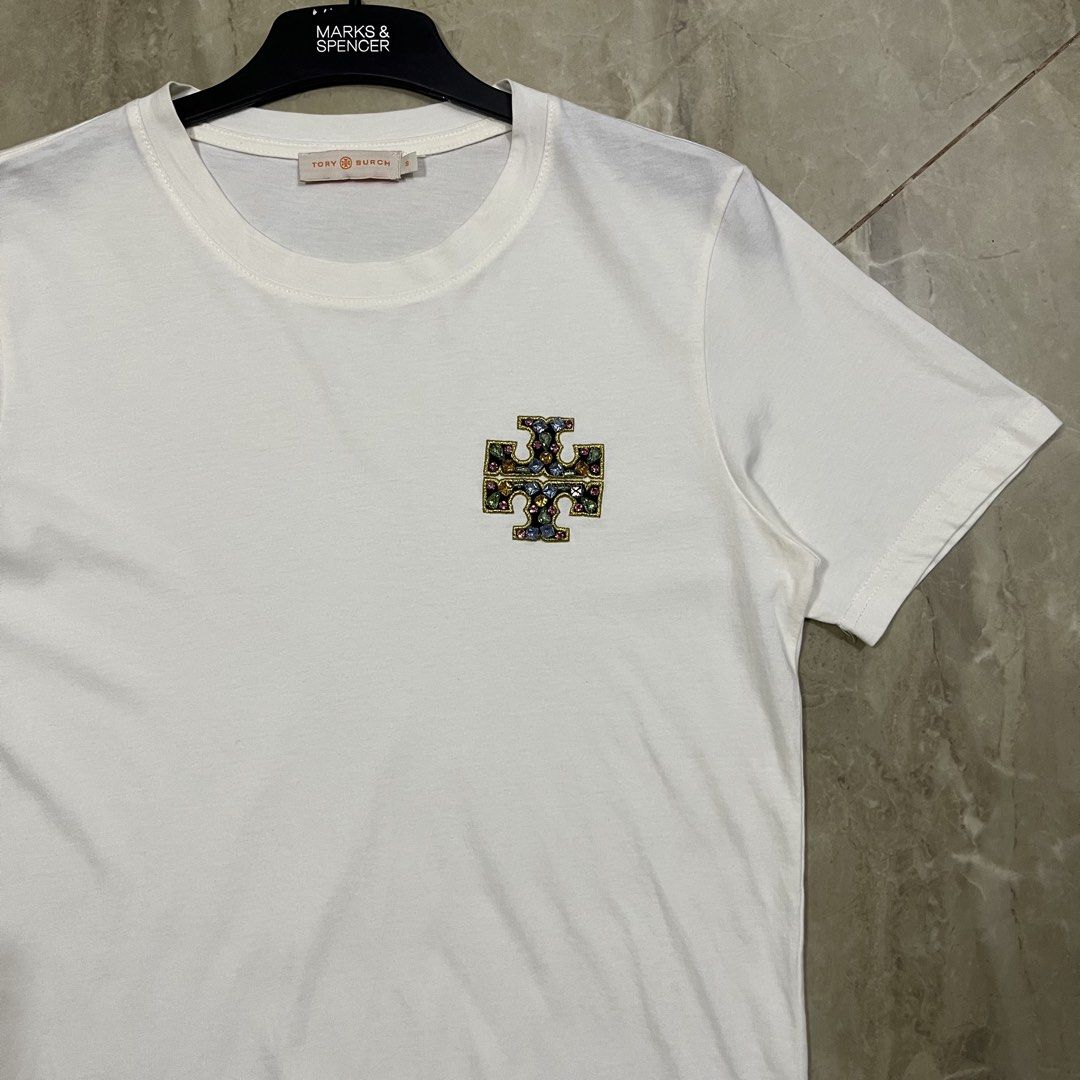 AUTHENTIC TORY BURCH EMBELLISHED LOGO SHIRT (Category: Luxury Apparel) located in Marikina City. Submitted by arniejane23 (Listing ID 1455373879, Image 2). Description: AUTHENTIC TORY BURCH EMBELLISHED LOGO SHIRT SIZE SMALL ON TAG DIMENSION width - 18.5 length - 24 NO ISSUE/NO FLAWS EXCELLENT LIKE NEW CONDITION!! 📩📩📩.