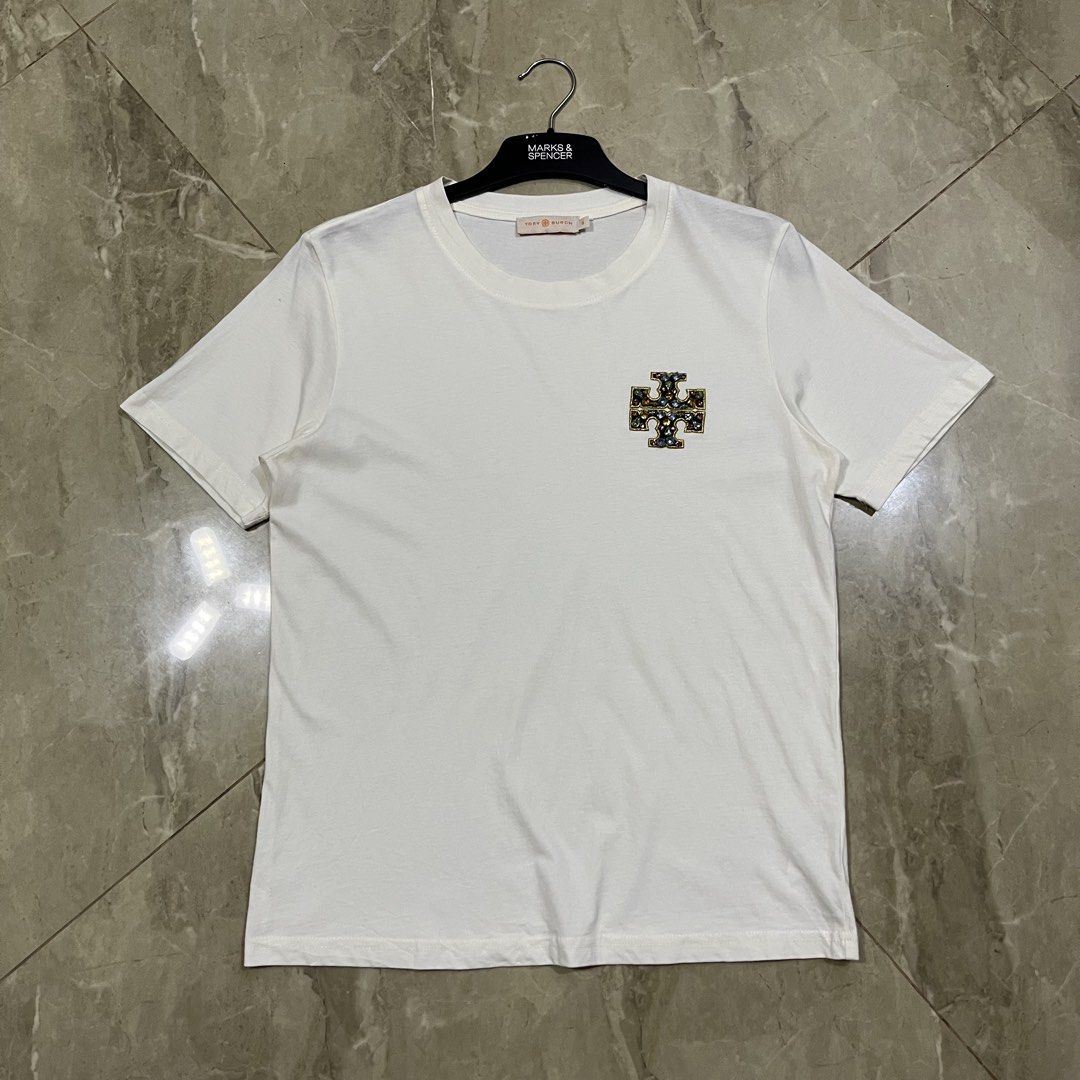 AUTHENTIC TORY BURCH EMBELLISHED LOGO SHIRT (Category: Luxury Apparel) located in Marikina City. Submitted by arniejane23 (Listing ID 1455373879, Image 1). Description: AUTHENTIC TORY BURCH EMBELLISHED LOGO SHIRT SIZE SMALL ON TAG DIMENSION width - 18.5 length - 24 NO ISSUE/NO FLAWS EXCELLENT LIKE NEW CONDITION!! 📩📩📩.