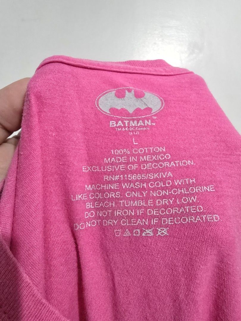 Batman Pink T-Shirt Size L (Category: Shirts) located in Quezon City. Submitted by eivan____orong (Listing ID 1455327179, Image 2). Description: - Pink t-shirt with silver Batman logo - Made in Mexico - 100% Cotton - Care: Machine wash cold, non-chlorine bleach only, tumble dry low - Do not iron if decorated - Ideal for any Batman fan! - Y2k vibes - (28L x 18W).