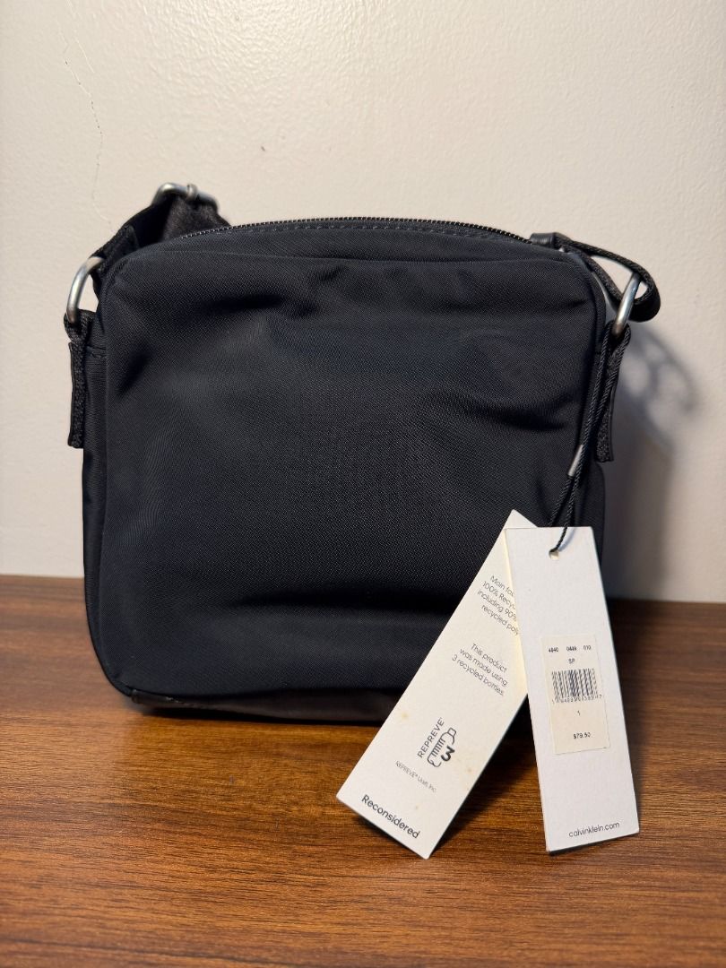 Black Nylon Crossbody Bag with Tags (Category: Cross-body Bags) located in San Fernando. Submitted by happyteynguin (Listing ID 1455327505, Image 2). Description: - Black nylon crossbody bag - Zipper closure - Original tags attached - Simple and practical design - Great for everyday use.