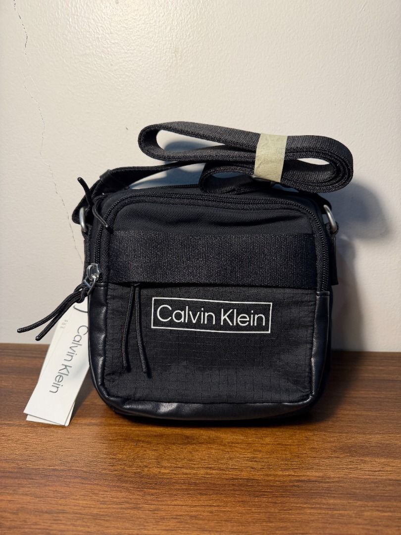 Black Nylon Crossbody Bag with Tags (Category: Cross-body Bags) located in San Fernando. Submitted by happyteynguin (Listing ID 1455327505, Image 1). Description: - Black nylon crossbody bag - Zipper closure - Original tags attached - Simple and practical design - Great for everyday use.