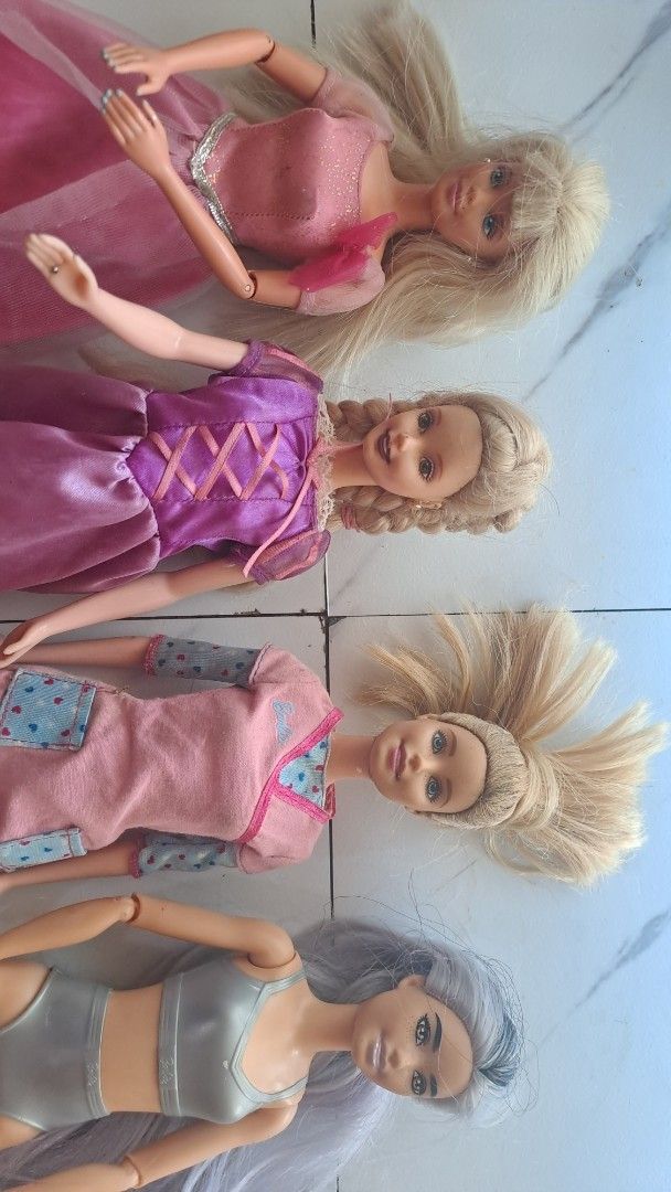 Bundle of 4 Barbie Dolls (Category: Kids Toys) located in Davao. Submitted by bravemoon_556cd5 (Listing ID 1455386345, Image 1). Description: - Bundle of 4 Barbie dolls - Includes: Princess doll, Rapunzel-inspired doll, Doctor/Nurse doll, Modern doll with grey hair - All dolls from a smoke-free home - Great for collectors or playtime.