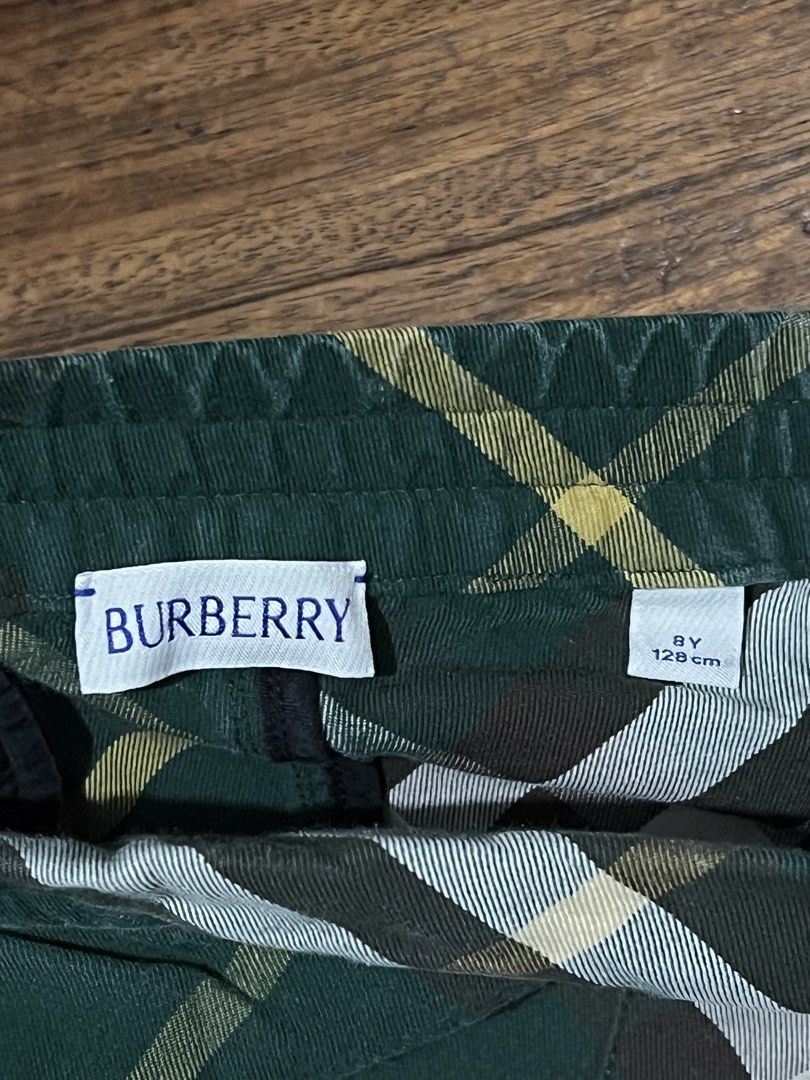 Burberry Plaid Shorts (Category: Babies & Kids Fashion) located in Quezon City. Submitted by ishaan1423 (Listing ID 1455390386, Image 3). Description: - Classic Burberry plaid shorts - Green base with yellow, white, and brown checks - Comfortable elastic waistband - Made in Thailand - 100% cotton fabric - Ideal for everyday wear or playtime.