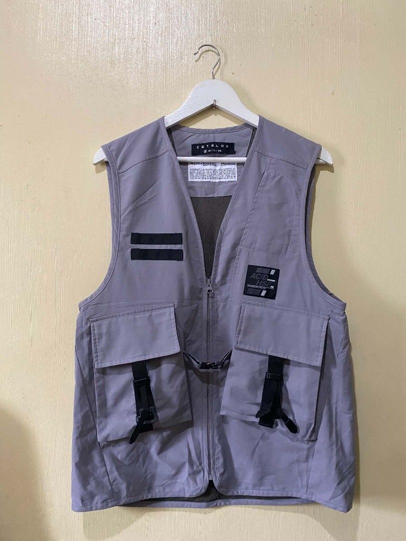 CATALOG Acid-House Geologic Temp Record Vest (Category: Vests) located in Manila. Submitted by cozci (Listing ID 1455372329, Image 1). Description: - CATALOG Grey Utility Vest - Unique Acid-House Geologic Temp Record design - Multiple pockets with buckle and strap closures - Mesh lining inside - Size: M / 175 / 92A - Material: Polyethylene.