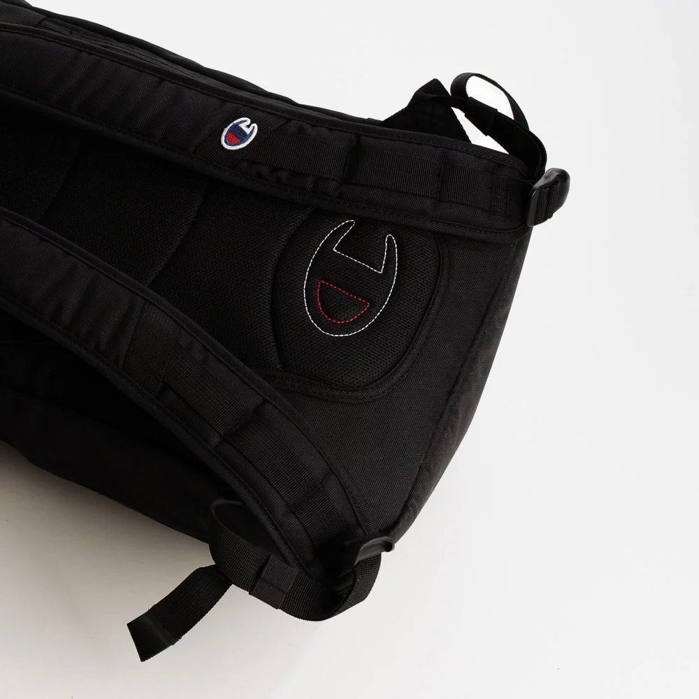 Champion Black Backpack (Category: Backpacks) located in San Fernando. Submitted by jecscollectionsshoppee (Listing ID 1455424555, Image 3). Description: - BRAND NEW black Champion backpack - Secure flap top with buckle closure - Two convenient front pockets with zip closures - Comfortable padded shoulder straps - Durable material for long-lasting use - Ideal for everyday adventures or travel.