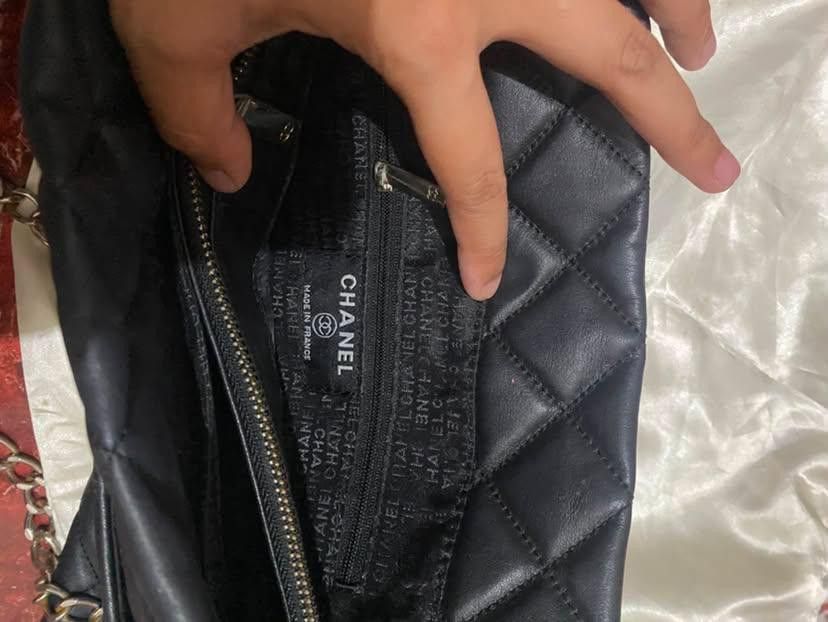 Chanel Quilted Leather Chain Shoulder/Tote Bag (Category: Luxury Bags & Wallets) located in Lucena. Submitted by minos_world (Listing ID 1455455812, Image 2). Description: Medium to large size - Black quilted leather - Silver-tone chain strap - Interior zippered pocket Issues: May bakat ng ipit and rust on the silver straps rfs nakita ko lang po yan sa ilalim ng kama.