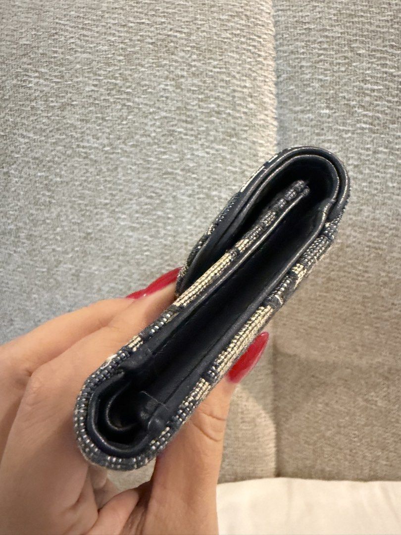 Christian Dior Saddle Wallet Oblique Canvas (Category: Luxury Bags & Wallets) located in Cainta. Submitted by lovelymart00300 (Listing ID 1455397945, Image 3). Description: - Authentic Dior Saddle Wallet - Iconic Oblique Canvas - Gold 'D' Charm Detail - Interior: Card slots & zip pocket - Navy Blue Leather Lining - Compact and Stylish - Perfect for Everyday Essentials.