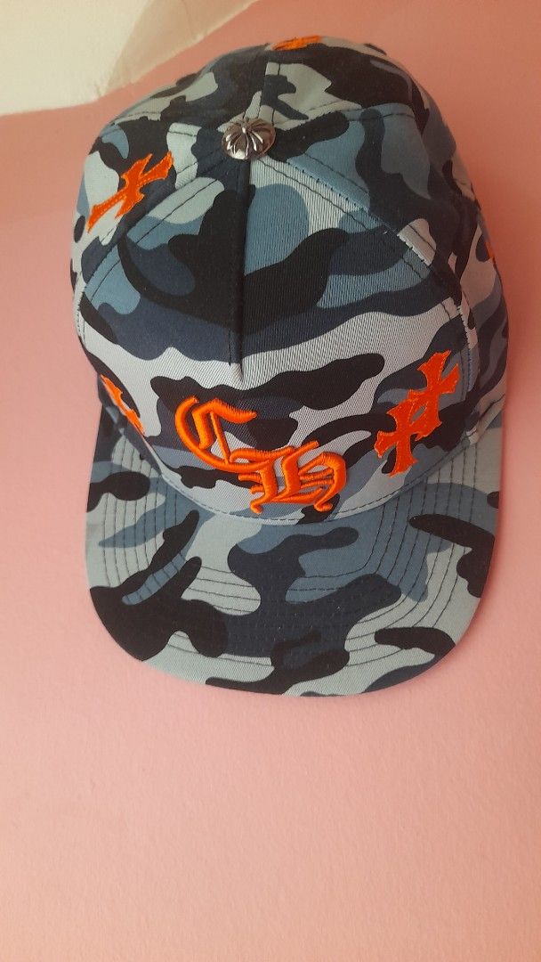 Chrome Hearts Camo Cap Orange Cross Logo (Category: Caps & Hats) located in Manila. Submitted by sec0ndbloom (Listing ID 1455353966, Image 1). Description: - Authentic Chrome Hearts cap - Stylish camouflage pattern - All-over orange cross logo detailing - Comfortable cotton and elastic construction - Perfect for adding an edgy vibe to your outfit.