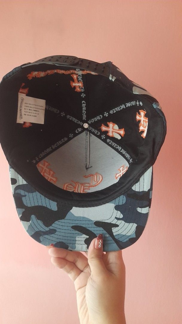 Chrome Hearts Camo Cap Orange Cross Logo (Category: Caps & Hats) located in Manila. Submitted by sec0ndbloom (Listing ID 1455353966, Image 2). Description: - Authentic Chrome Hearts cap - Stylish camouflage pattern - All-over orange cross logo detailing - Comfortable cotton and elastic construction - Perfect for adding an edgy vibe to your outfit.