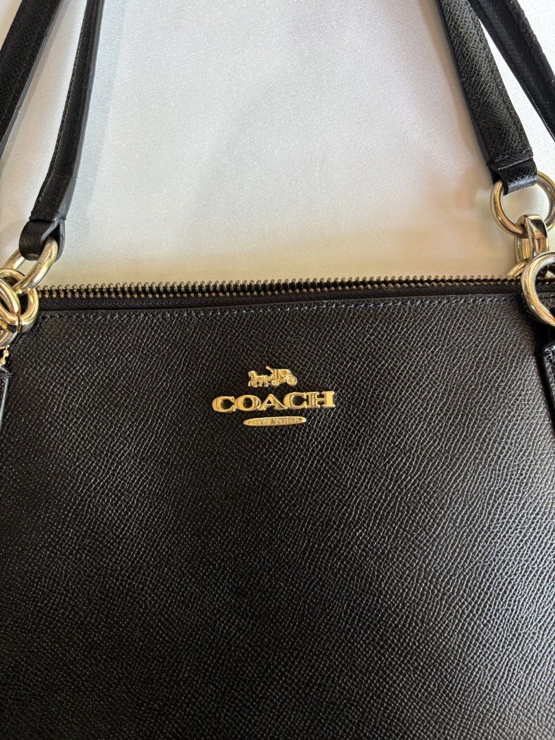 Coach Black Leather Tote Bag (Category: Luxury Bags & Wallets) located in Iloilo. Submitted by iconicangie (Listing ID 1455357753, Image 2). Description: - Classic black Coach tote bag - Textured leather with gold hardware details - Interior zippered pocket and slip pocket - Made in Cambodia - Great everyday bag for essentials.