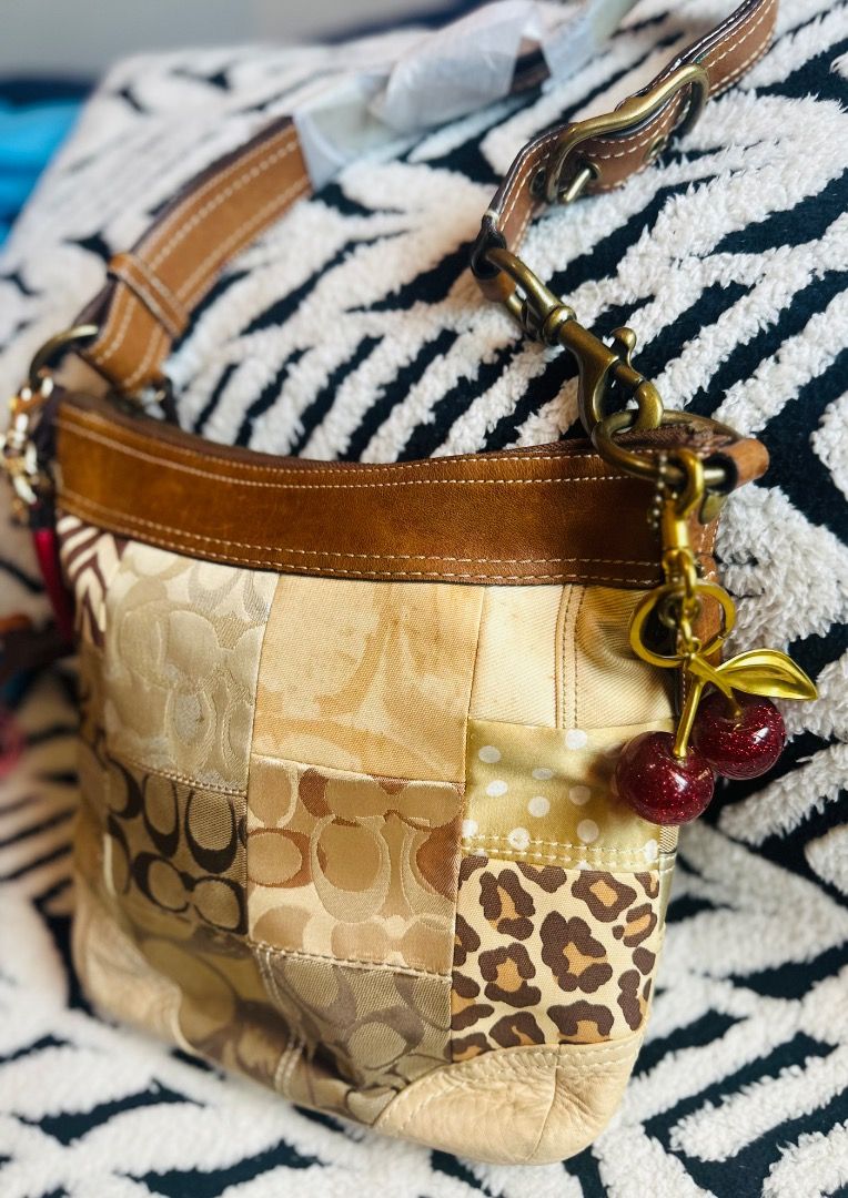 Coach Patchwork Signature Hobo Bag (Category: Luxury Bags & Wallets) located in Cebu City. Submitted by isellhere123.543 (Listing ID 1455338936, Image 3). Description: - Adorable Coach hobo bag - Unique patchwork design with 'C' logos, animal prints, and solid panels - Genuine leather trim and strap - Interior zip and slip pockets for organization - Charms not included - Ideal for everyday style and practicality.