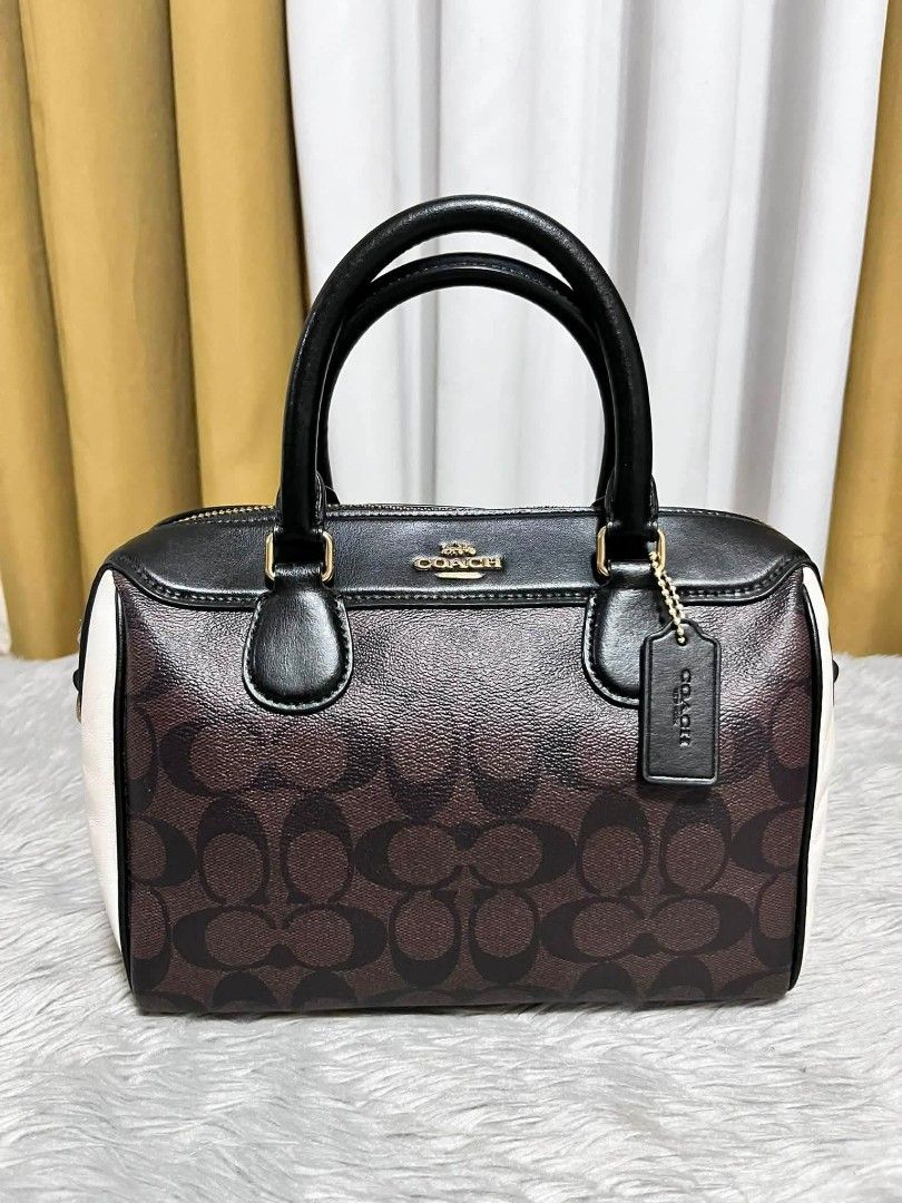 Coach Signature Monogram Boston Bag (Category: Luxury Bags & Wallets) located in Nagcarlan. Submitted by mitasBag20. (Listing ID 1455365859, Image 1). Description: -100% Legit From Japan DM me for my Page - Classic Coach monogram Boston bag - Signature brown and black print - Black leather handles and trim - White side panels - Gold hardware details - Includes Coach leather hangtag - Zipper closure.