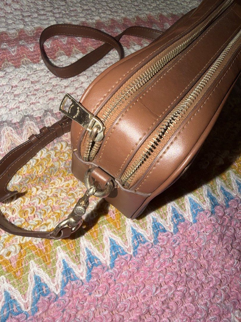 Coach Signature Monogram Crossbody Bag (Category: Luxury Bags & Wallets) located in Quezon City. Submitted by miccosredtruck (Listing ID 1455461534, Image 2). Description: - Authentic brown Coach crossbody bag - Signature monogram pattern with leather trim - Gold-tone hardware - Secure zipper closure - Interior Coach authenticity tag - Ideal for everyday wear.