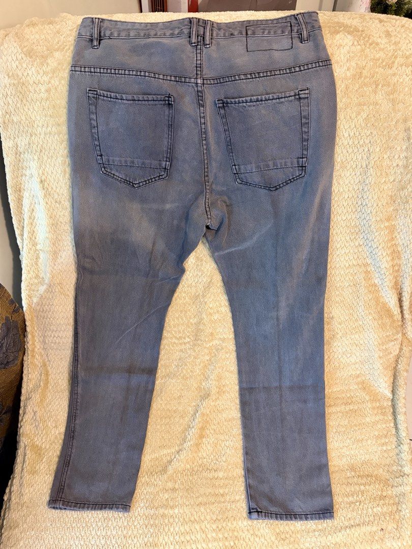 Cotton On Distressed Denim Jeans Size 34 (Category: Jeans) located in Taguig. Submitted by domie (Listing ID 1455378225, Image 3). Description: Grey denim jeans, EST:NINETEEN, Size 34. Features a distressed rip on the left knee and a straight leg fit. Button/zip closure, two back pockets. Perfect for casual outings..