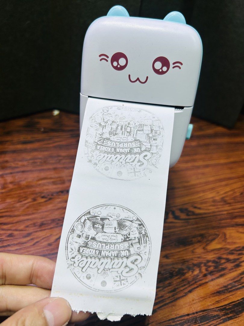 Cute Cat Portable Mini Photo Printer with Phone App (Category: Printers, Scanners & Copiers) located in Manila. Submitted by starbalesukandjapansurplus (Listing ID 1455461517, Image 2). Description: - Print stickers and labels directly from your phone. - Connects wirelessly via Bluetooth. - Features an adorable cute cat design. - Ideal for journaling, organizing, and crafting projects. - User-friendly app for easy operation. - Produces clear and 