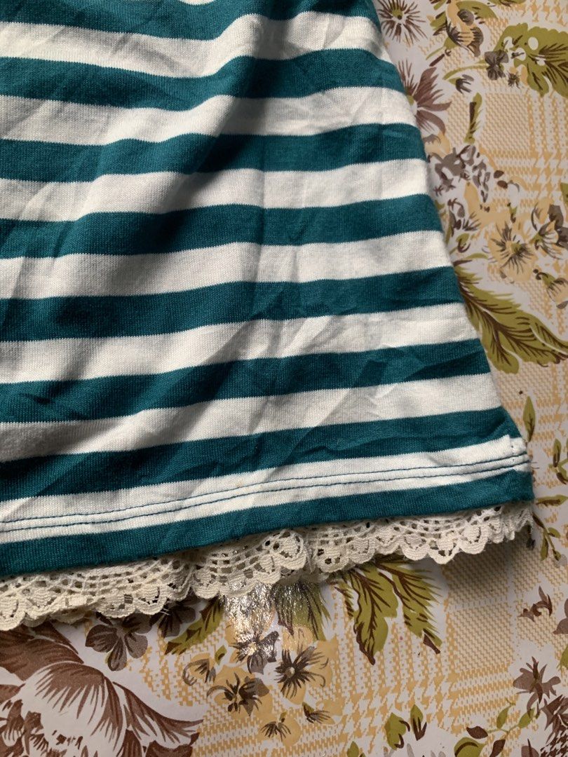 Estacot Striped Tank Top with Lace (Category: Sleeveless) located in Cebu City. Submitted by selamethrift (Listing ID 1455396780, Image 3). Description: - Green and white striped tank top - Features lace trim along the neckline and hem - Pretty embroidered detail on the chest - Ruffled straps for a feminine touch .