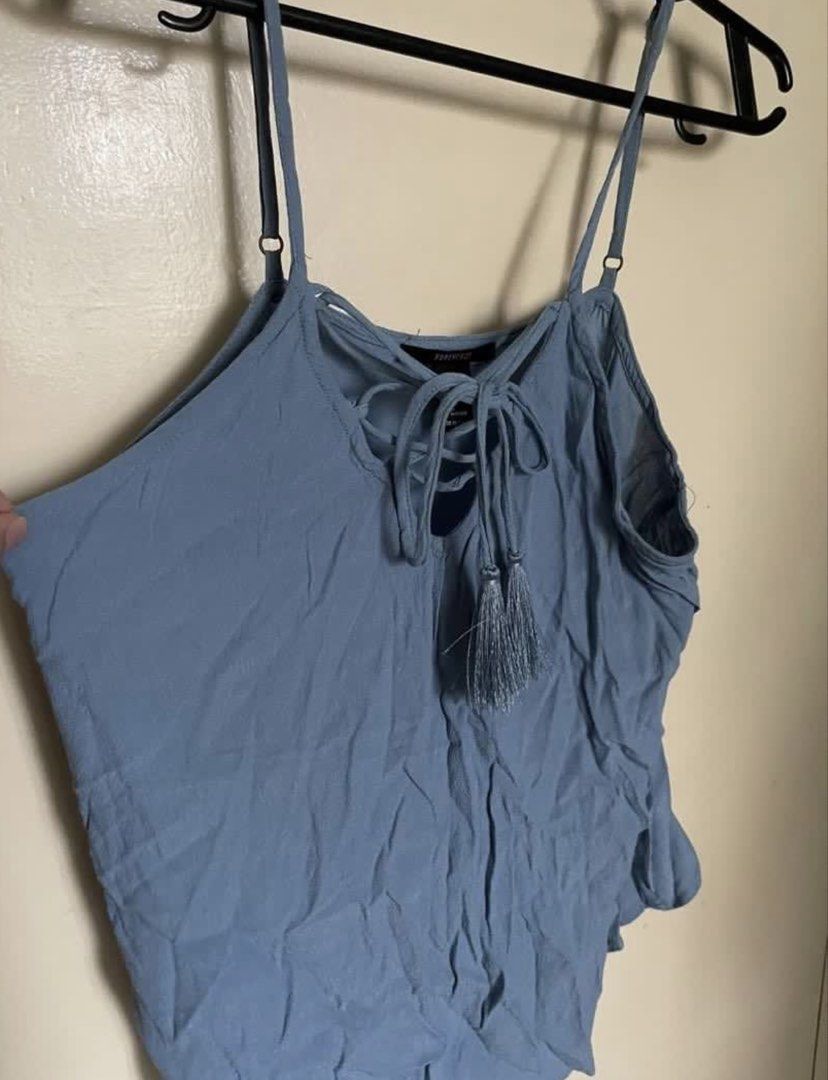 Forever 21 Blue Lace-Up Tassel Cami Top (Category: Sleeveless) located in Cebu City. Submitted by lucypim (Listing ID 1455442113, Image 3). Description: - Cute blue cami top from Forever 21 - Features a lace-up front with tassel details - Adjustable straps for a comfortable fit - Perfect for casual wear or layering - Size M (EU 38), fits small to medium frames.