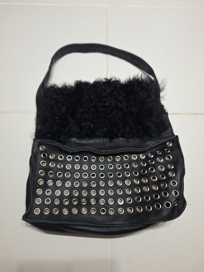 Genuine Leather and Fur Studded Shoulder Bag (Category: Shoulder Bags) located in Las Pinas. Submitted by second.founds (Listing ID 1455398682, Image 1). Description: Fur and Grommet bag - 14 inches by 14 inches Strap 23 inches -What you see is what you get. -Lightly used -Mop: gcash / bdo -courier: ggx - Cool black leather shoulder bag - Fuzzy black fur accent on one side - Metal studs on the front panel - Zipper closure - Leather strap with sti