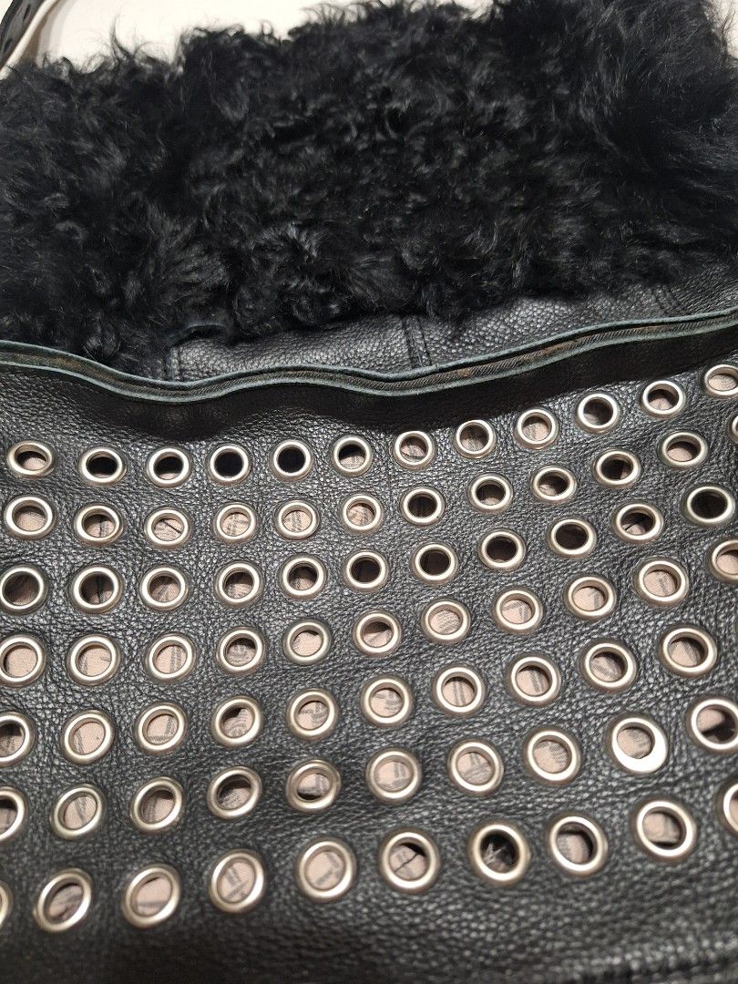 Genuine Leather and Fur Studded Shoulder Bag (Category: Shoulder Bags) located in Las Pinas. Submitted by second.founds (Listing ID 1455398682, Image 2). Description: Fur and Grommet bag - 14 inches by 14 inches Strap 23 inches -What you see is what you get. -Lightly used -Mop: gcash / bdo -courier: ggx - Cool black leather shoulder bag - Fuzzy black fur accent on one side - Metal studs on the front panel - Zipper closure - Leather strap with sti