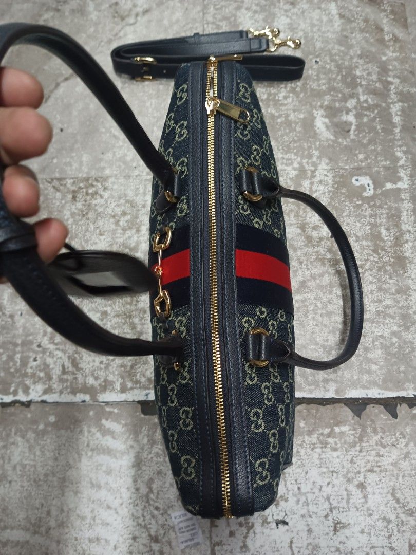 Gucci Monogram Denim Vintage Boston Bag (Category: Luxury Bags & Wallets) located in Baguio. Submitted by brandeditems16 (Listing ID 1455495996, Image 3). Description: - Classic Gucci Boston bag - Iconic GG monogram on denim canvas - Signature red and blue stripe detail - Detachable shoulder strap included - Gold hardware - Zipper closure - Spacious interior - Comes with a leather tag.