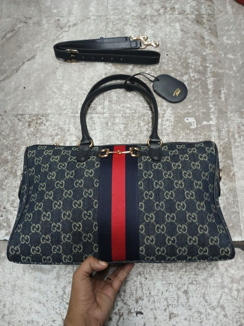 Gucci Monogram Denim Vintage Boston Bag (Category: Luxury Bags & Wallets) located in Baguio. Submitted by brandeditems16 (Listing ID 1455495996, Image 1). Description: - Classic Gucci Boston bag - Iconic GG monogram on denim canvas - Signature red and blue stripe detail - Detachable shoulder strap included - Gold hardware - Zipper closure - Spacious interior - Comes with a leather tag.
