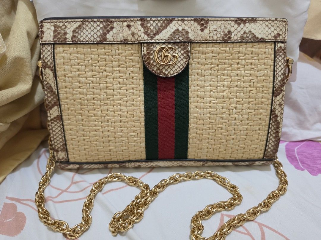 Gucci Raffia Elaphe Shoulder Bag (Category: Luxury Bags & Wallets) located in Cavite. Submitted by kazi_preloved (Listing ID 1455410521, Image 1). Description: - 100% Authentic GUCCI Ophidia Crossbody Bag Snake Leather Raffia Chain Shoulder Purse - Woven straw body with snake trim - with iconic sherryline stripe detail - Gold chain strap - clean interior - with original dust bag.