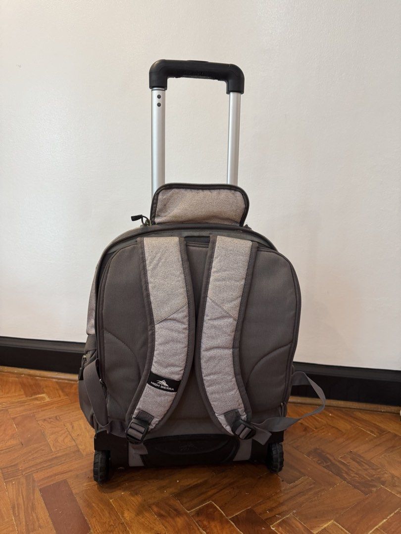 High Sierra Rolling Backpack Luggage Grey (Category: Backpacks) located in Makati City. Submitted by offthemetro (Listing ID 1455330703, Image 2). Description: - Grey High Sierra rolling backpack - Features wheels and a retractable handle for easy transport - Multiple compartments for organized storage - Includes padded shoulder straps for alternative carrying - Handle shows some wear but is fully functional - Perfect for travel or school use 💡H