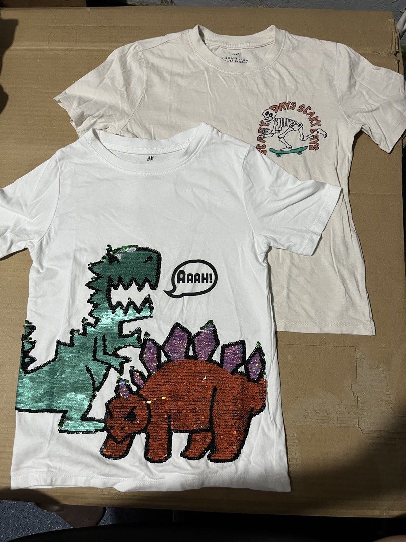 H&M 4 T-shirts BUNDLE! WITH FREEBIE Sando (Category: Babies & Kids Fashion) located in Manila. Submitted by hi_abbd (Listing ID 1455477168, Image 2). Description: - Bundle of 4 H&M t-shirts for boys - Includes 2 striped t-shirts (white with blue stripes and pocket, off-white with brown stripes) - Also includes 2 graphic t-shirts (one with dinosaurs and sequins, one with a skeleton graphic) - All are short-sleeved with crew necks - Perfect for cas