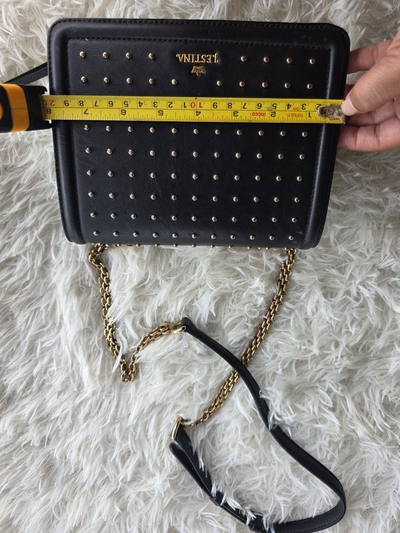 j.estina Black Studded Chain Shoulder Bag (Category: Shoulder Bags) located in Lemery. Submitted by venus23 (Listing ID 1455325828, Image 3). Description: - Brand: J.ESTINA - Color: Black - Design: All-over gold stud embellishments - Strap: Gold chain strap (note: some wear and tear on one side) - Features: Back slip pocket - Approximate Dimensions: 7 inches (height) x 5.5 inches (width).