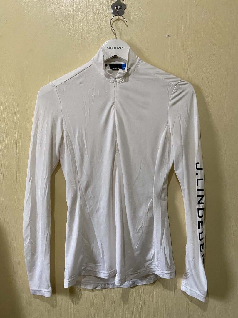 j.lindeberg White Long Sleeve Golf Top (Category: Golf) located in Manila. Submitted by cozci (Listing ID 1455372199, Image 1). Description: - Brand: J.Lindeberg - Color: White - Style: Long sleeve top - Features: Quarter zip neckline, J.Lindeberg logo on sleeve and back collar - Perfect for: Golf, activewear, layering - Material: Comfortable and breathable.