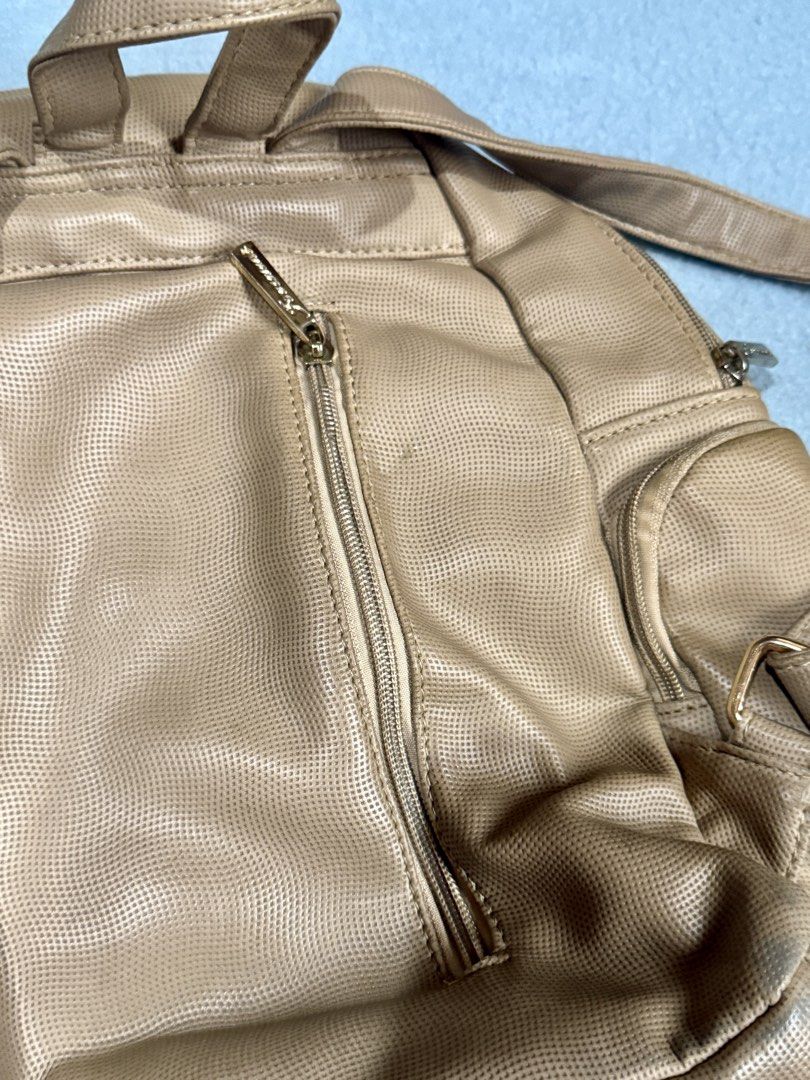 Jovanni Beige Perforated Faux Leather Mini Backpack (Category: Backpacks) located in Santa Rosa. Submitted by _annepo (Listing ID 1455355172, Image 3). Description: Cute beige Jovanni mini backpack. Faux leather with perforated texture. Main zip compartment, front zip pocket, gold hardware. Adjustable straps. Perfect for daily use..