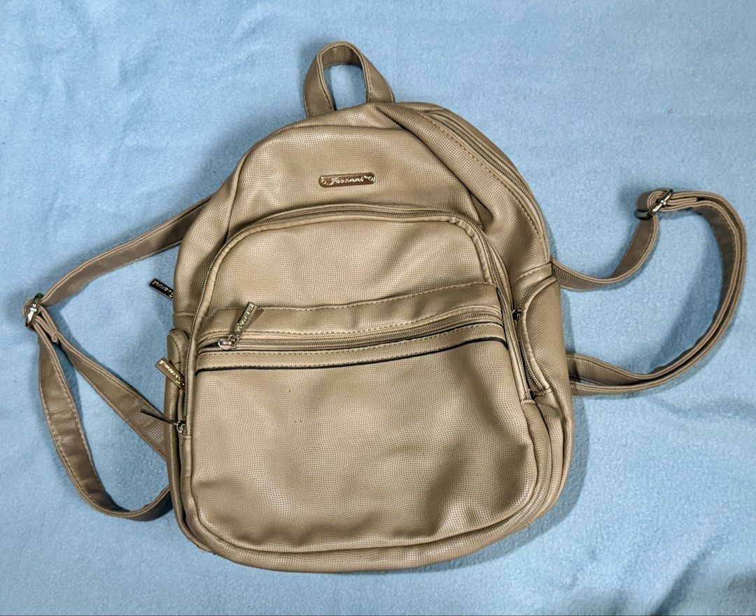 Jovanni Beige Perforated Faux Leather Mini Backpack (Category: Backpacks) located in Santa Rosa. Submitted by _annepo (Listing ID 1455355172, Image 2). Description: Cute beige Jovanni mini backpack. Faux leather with perforated texture. Main zip compartment, front zip pocket, gold hardware. Adjustable straps. Perfect for daily use..