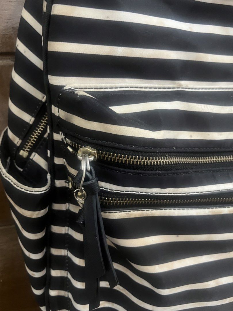 Kate Spade New York Striped Backpack (Category: Backpacks) located in Quezon City. Submitted by ch0wy (Listing ID 1455345386, Image 3). Description: - ORIGINAL Classic black and white striped backpack by Kate Spade. (Note: PLEASE LOWER YOUR EXPECTATIONS AS THIS IS ALREADY A PRE-LOVED BAG, THIS BAG NEEDS CLEANING TOO SINCE DI KO NA TALAGA NAGAMIT BUT ALL IN ALL STILL WORTH IT) - Multiple zippered compartments and pockets for organization. - Interi