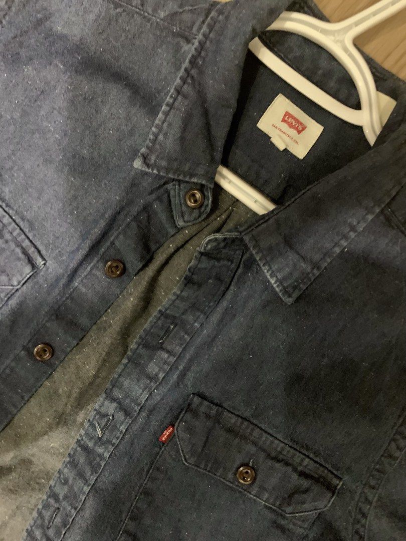 Levi's Dark Wash Denim Button-Up Shirt (Category: Tshirts & Polo Shirts ) located in Antipolo. Submitted by junifer09 (Listing ID 1455473706, Image 2). Description: - Classic Levi's denim shirt - Dark blue wash with subtle speckled texture - Two chest pockets with button closures - Button-down front - Versatile for layering or wearing solo.