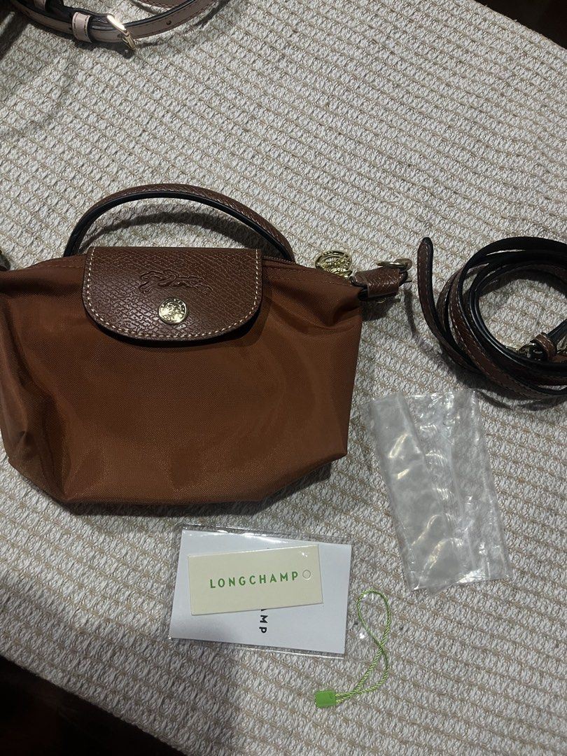 Longchamp Le Pliage Original Pouch with Handle Brown (Category: Luxury Bags & Wallets) located in Manila. Submitted by janinayours (Listing ID 1455472330, Image 2). Description: - Authentic Longchamp Le Pliage pouch - Color: Brown - Includes handle and detachable shoulder strap - Comes with authenticity card and dust bag - Ideal for organizing essentials or as a small clutch.