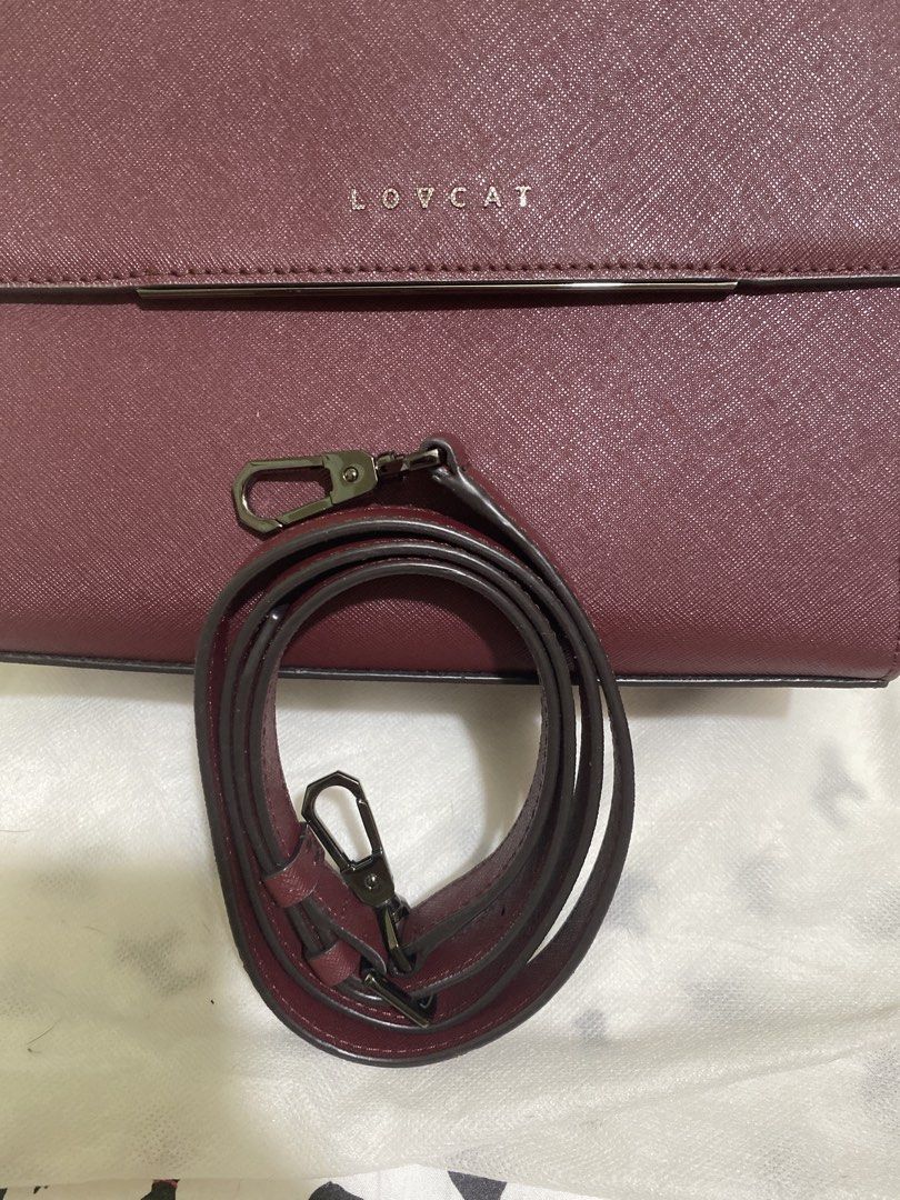 LOVCAT Burgundy Structured Top Handle Bag with Pom Pom Charm (Category: Purses & Pouches) located in Quezon City. Submitted by jenjen2829 (Listing ID 1455339801, Image 3). Description: - Brand: LOVCAT, in excellent used condition - Color: Burgundy - Style: Structured handbag - Features: Top handle, detachable crossbody strap - Material: Textured crosshatch - Hardware: gunmetal - Includes: Cute fluffy pom pom charm - Versatile: Ideal for everyday 