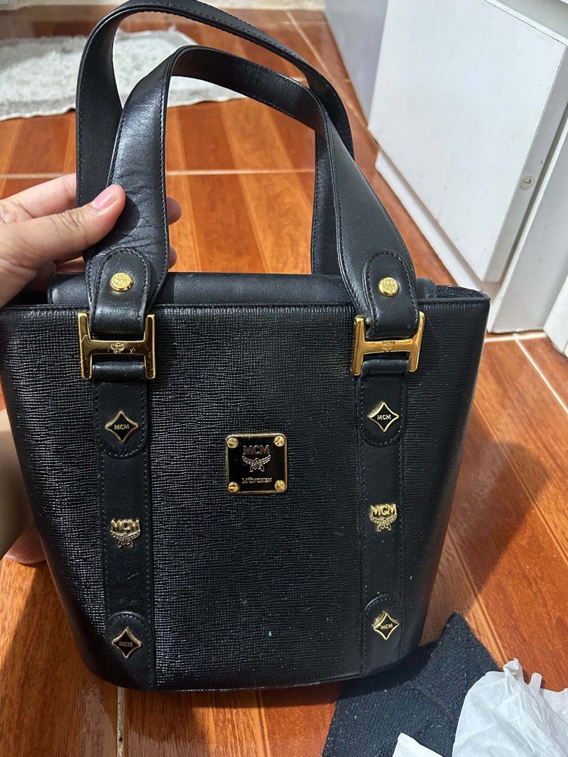 MCM Black Leather Tote Bag (Category: Luxury Bags & Wallets) located in Caloocan City. Submitted by jill262626 (Listing ID 1455387744, Image 1). Description: - Classic black MCM tote bag - Genuine leather material - Elegant gold hardware - Multiple interior compartments for organization - Comfortable top handles for carrying - A timeless and versatile piece for everyday style - authentic .