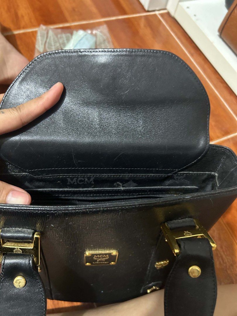 MCM Black Leather Tote Bag (Category: Luxury Bags & Wallets) located in Caloocan City. Submitted by jill262626 (Listing ID 1455387744, Image 2). Description: - Classic black MCM tote bag - Genuine leather material - Elegant gold hardware - Multiple interior compartments for organization - Comfortable top handles for carrying - A timeless and versatile piece for everyday style - authentic .