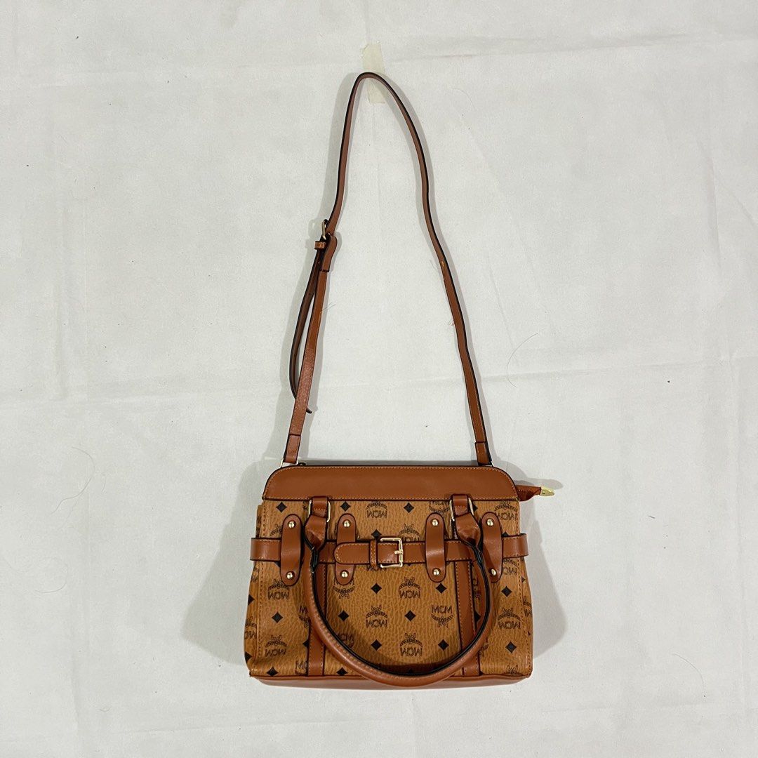 MCM Monogrammed Brown Leather Handbag with Shoulder Strap (Category: Luxury Bags & Wallets) located in Cavite. Submitted by itsayaaa (Listing ID 1455469352, Image 3). Description: MCM Bag Issue: No issue Condition: Excellent Condition STARTING BID: 150 INCREMENT: 50 CLAIM: 📥.