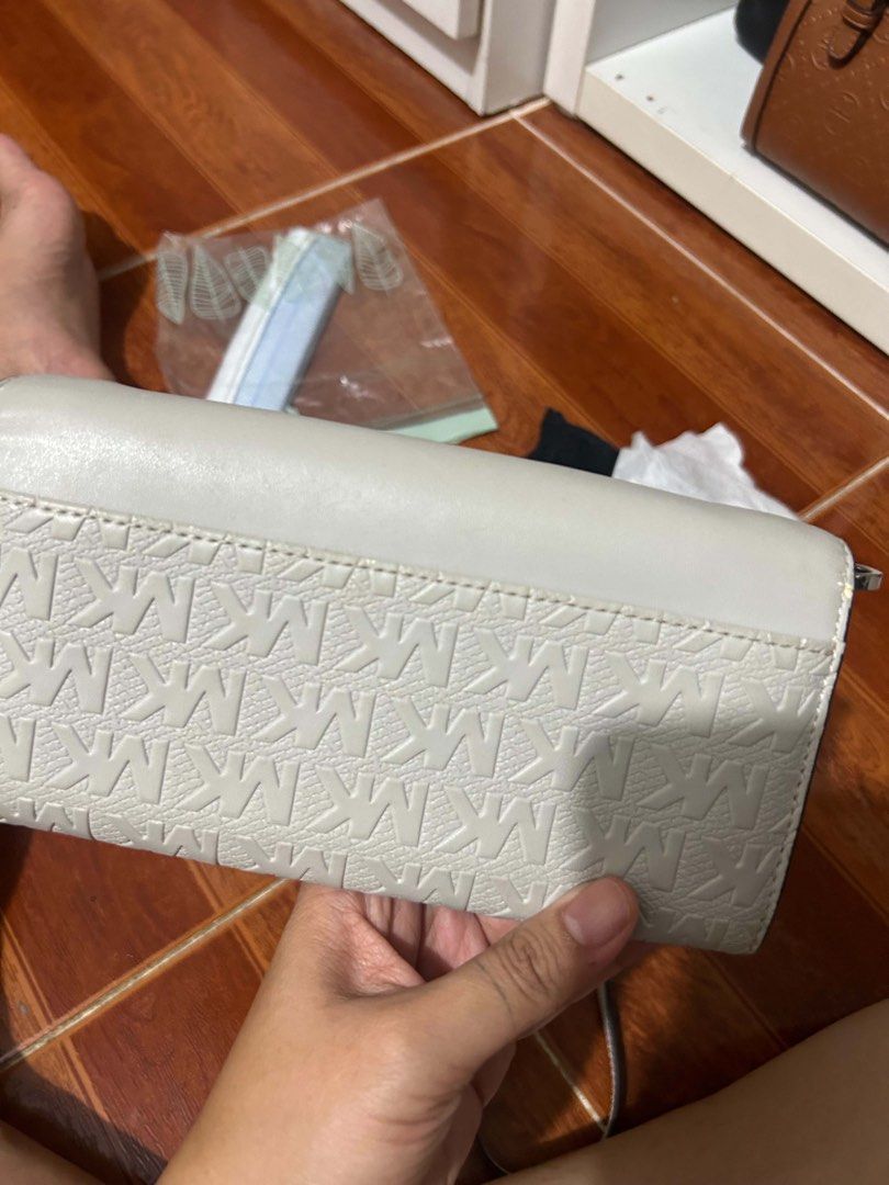 Michael Kors Wallet Clutch (Category: Luxury Bags & Wallets) located in Caloocan City. Submitted by jill262626 (Listing ID 1455331533, Image 2). Description: - Michael Kors wallet in light grey - Features embossed MK logo pattern on the front flap - Multiple card slots inside - Includes a zip pocket - Comes with a detachable strap - Ideal for carrying your daily essentials -authentic.