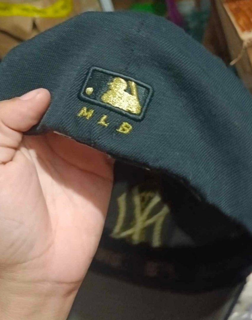 New York Yankees MLB Baseball Cap (Category: Caps & Hats) located in Caloocan City. Submitted by rtarellano (Listing ID 1455390750, Image 3). Description: - Black New York Yankees Cap - Gold NY logo on front - MLB logo on side - Size: M-XL - Shows some wear on brim and inside - Great for any Yankees fan.