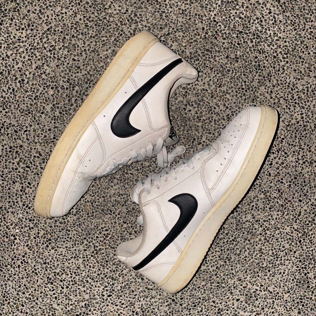 Nike Court Vision size 9 (Category: Sneakers) located in Manila. Submitted by johnpm (Listing ID 1455464467, Image 1). Description: - Classic white Nike low-top sneakers - Features iconic black swoosh - Light blue laces add a pop of color - Soles show slight yellowing due to age - Minor scuffs and marks on leather, consistent with wear - Still a durable and stylish pair for everyday use.